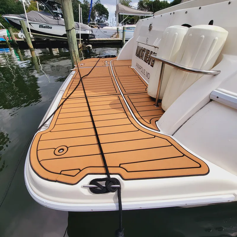 Slide: The Image of 1999 Cruisers Yachts 3075 Rogue with teak-style swim platform at marina. - 7