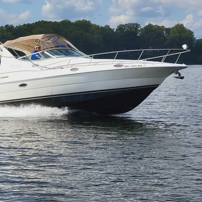 Slide: The Image of 1999 Cruisers Yachts 3075 Rogue cruising on a serene lake. - 8