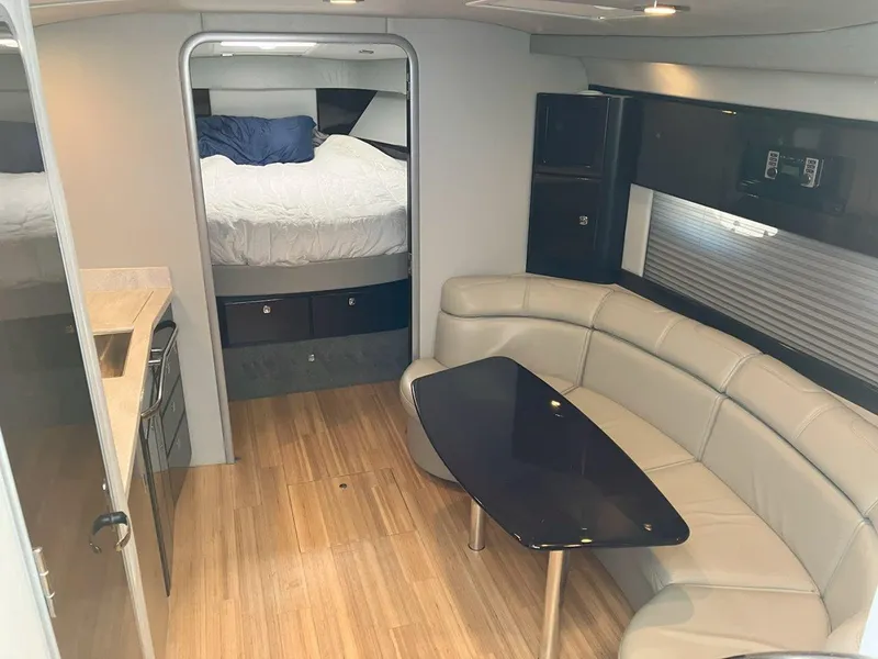 Slide: The Image of 2016 Formula 37 PC yacht interior with modern seating, table, and cozy bedroom. - 34