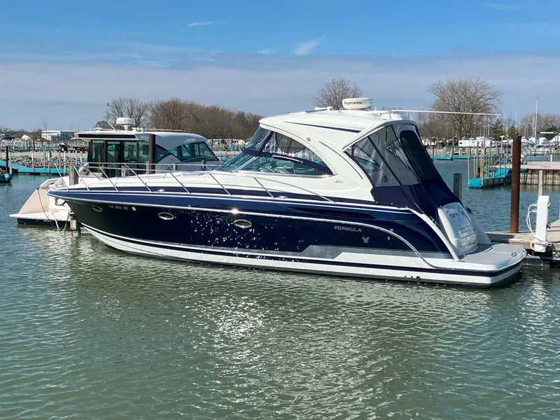 Slide: The Image of 2016 Formula 37 PC yacht docked in a marina, featuring sleek design and blue accents. - 5