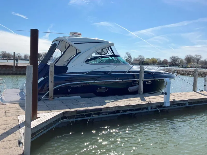 Slide: The Image of 2016 Formula 37 PC yacht docked at a marina under clear blue skies. - 8
