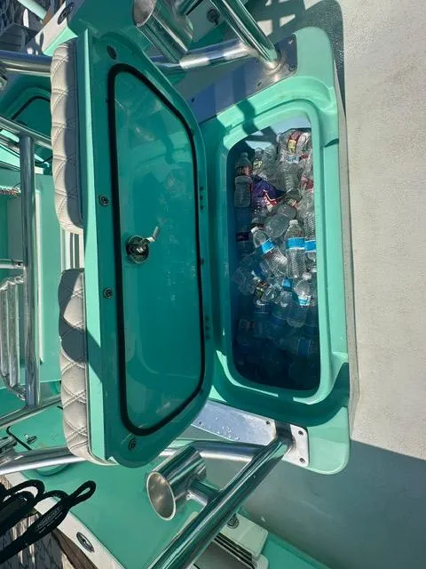 Slide: The Image of 2022 Shallow Sport 28 X3 boat cooler filled with ice and bottled drinks. - 13