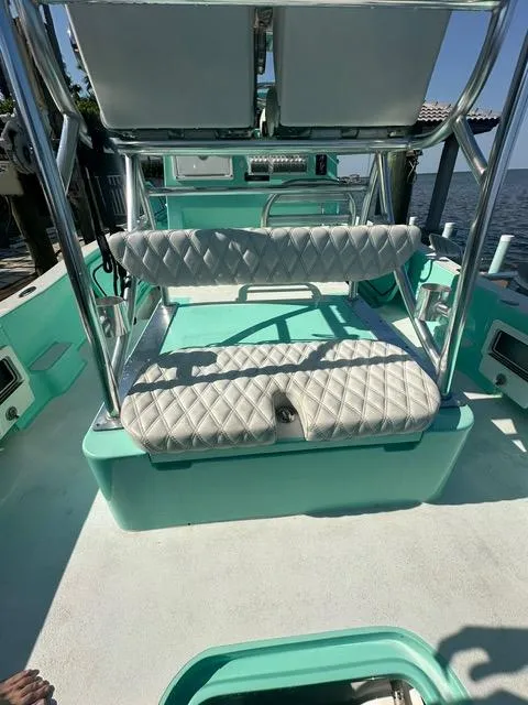Slide: The Image of 2022 Shallow Sport 28 X3 boat with white seating and teal accents. - 14