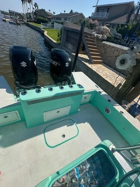 Slide: The Image of 2022 Shallow Sport 28 X3 boat with dual Suzuki engines docked by waterfront homes. - 16