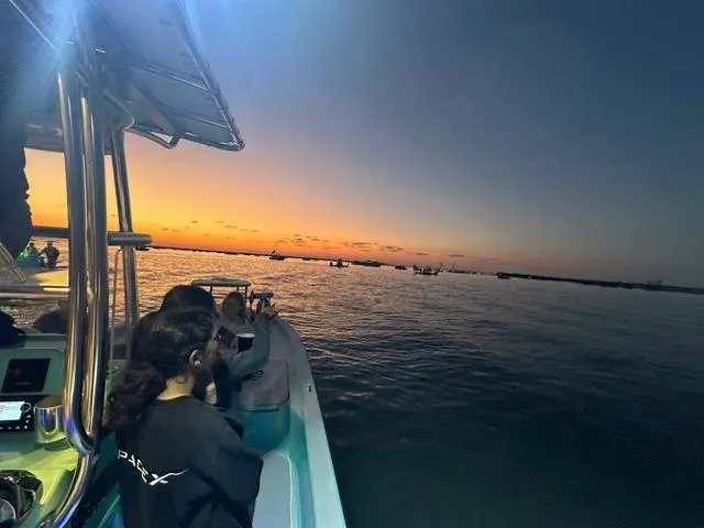 Slide: The Image of 2022 Shallow Sport 28 X3 boat at sunset with passengers enjoying the view. - 20