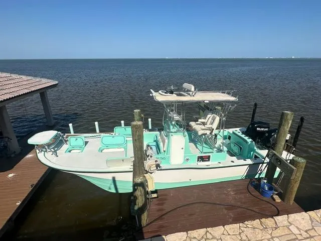 Slide: The Image of 2022 Shallow Sport 28 X3 boat docked by the water on a sunny day. - 5