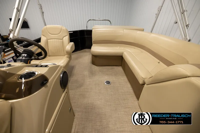 Slide: The Image of Interior of 2017 Crest 200 L CPT pontoon boat with beige seating and steering console. - 14