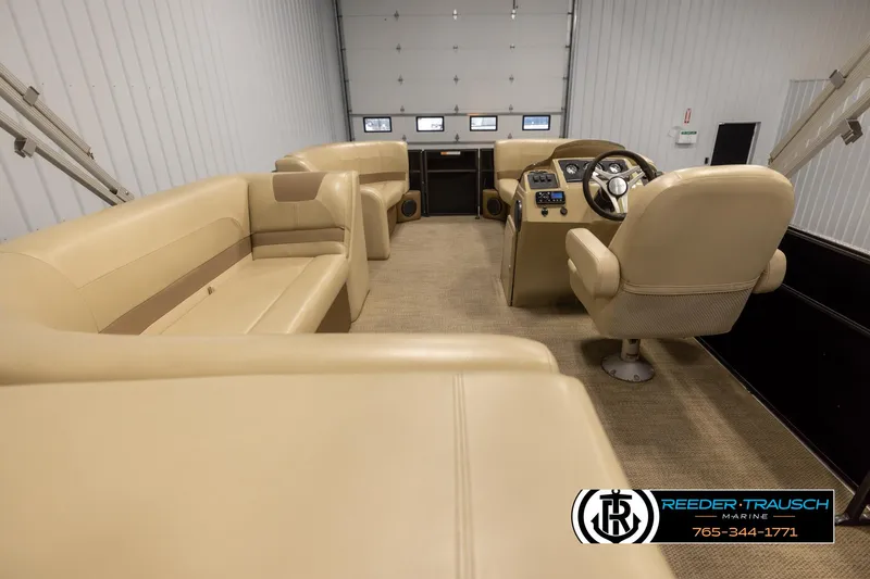 Slide: The Image of 2017 Crest 200 L CPT pontoon boat interior with beige seating and control panel. - 16