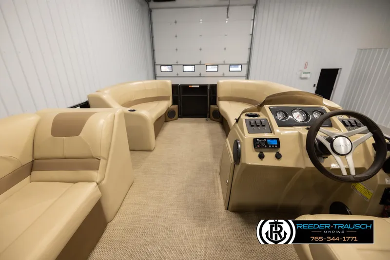 Slide: The Image of 2017 Crest 200 L CPT pontoon boat interior with beige seating and control panel. - 17