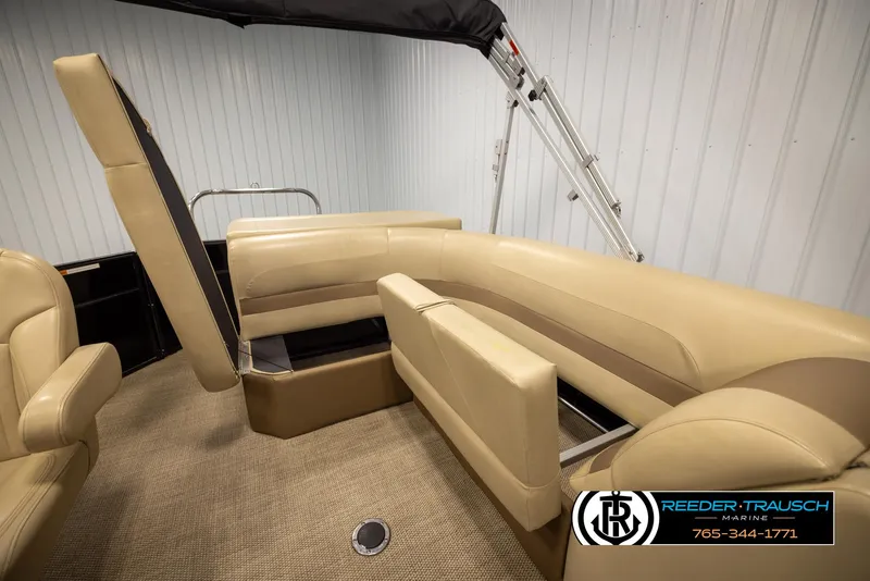 Slide: The Image of 2017 Crest 200 L CPT pontoon boat interior with beige seating and storage compartments. - 21