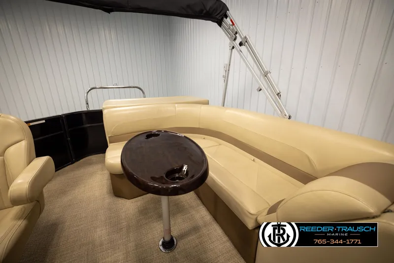 Slide: The Image of 2017 Crest 200 L CPT pontoon boat interior with beige seating and a round table. - 22