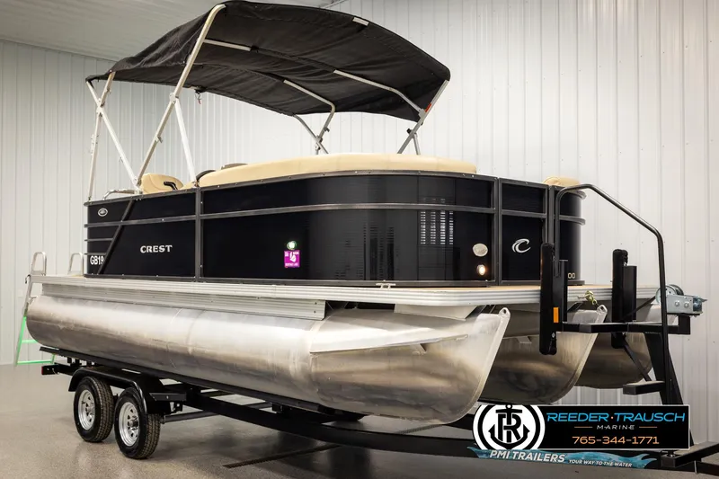 Slide: The Image of 2017 Crest 200 L CPT pontoon boat on trailer in indoor showroom. - 3
