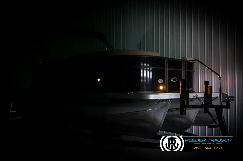 Slide: The Image of 2017 Crest 200 L CPT pontoon boat in dimly lit storage facility. - 4