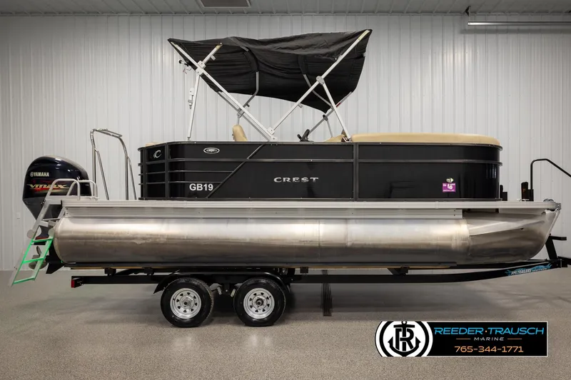 Slide: The Image of 2017 Crest 200 L CPT pontoon boat with canopy on trailer in showroom. - 5