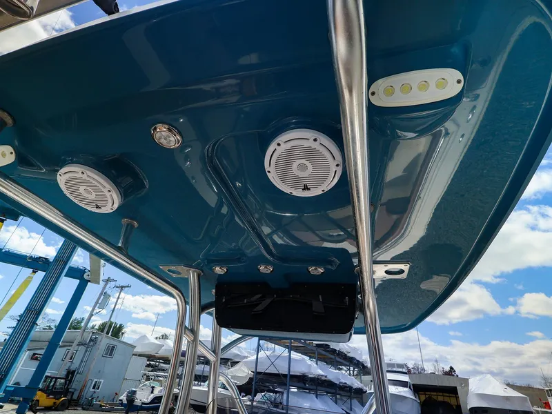 Slide: The Image of 2022 Pioneer 222 Islander boat with blue canopy, speakers, and lights. - 11