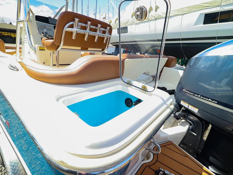 Slide: The Image of 2022 Pioneer 222 Islander boat with seating, livewell, and outboard motor. - 13