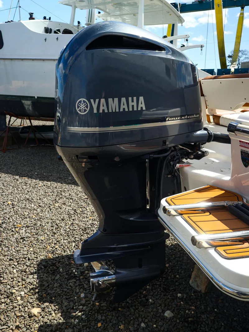 Slide: The Image of Yamaha outboard motor on 2022 Pioneer 222 Islander boat, displayed outdoors. - 17