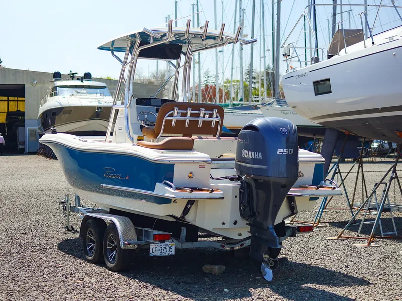Slide: The Image of 2022 Pioneer 222 Islander boat with Yamaha 250 engine on trailer in marina. - 18