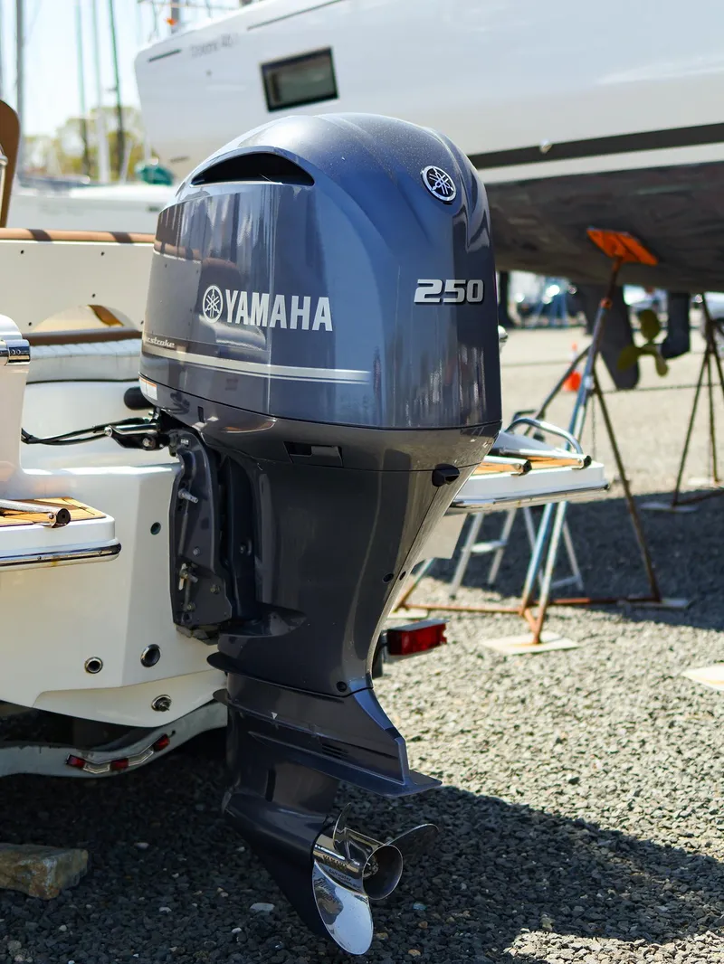 Slide: The Image of 2022 Pioneer 222 Islander with Yamaha 250 outboard motor in a boatyard setting. - 19
