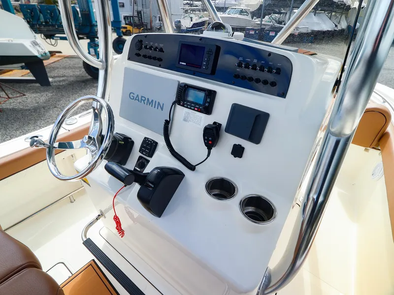Slide: The Image of 2022 Pioneer 222 Islander boat dashboard with Garmin navigation system and controls. - 8