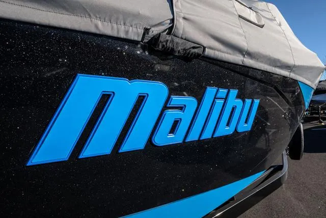 Slide: The Image of 2023 Malibu 26 LSV boat with blue logo and protective cover. - 3