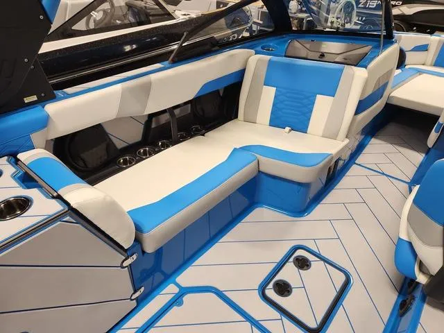 Slide: The Image of 2023 Malibu 26 LSV boat interior with blue and white seating and modern design. - 43