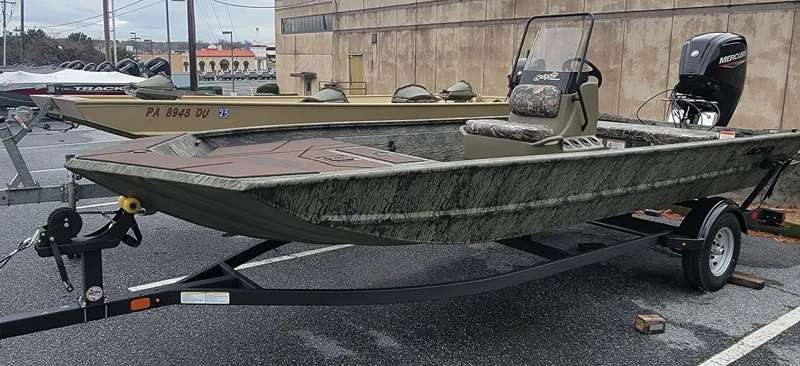 Slide: The Image of 2025 Tracker Grizzly 1860 CC boat on trailer, parked outdoors. - 3