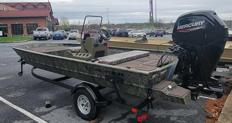Slide: The Image of 2025 Tracker Grizzly 1860 CC boat with Mercury engine in parking lot. - 4