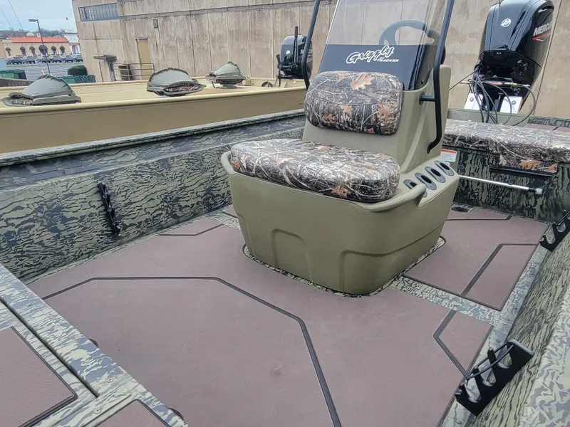 Slide: The Image of 2025 Tracker Grizzly 1860 CC boat interior with camouflage seating and console. - 9
