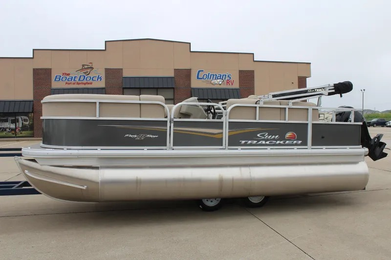 The Image of 2025 Sun Tracker Party Barge 18 DLX pontoon boat parked outside dealership. - 0
