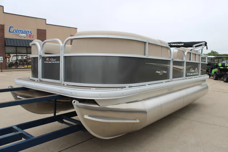Slide: The Image of 2025 Sun Tracker Party Barge 18 DLX pontoon boat on trailer at dealership. - 7