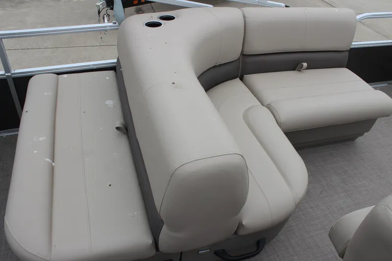 Slide: The Image of 2025 Sun Tracker Party Barge 18 DLX pontoon boat seating area with beige upholstery. - 9