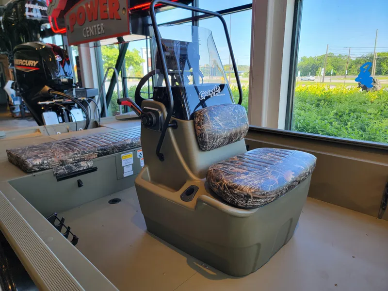 Slide: The Image of 2025 Tracker Grizzly 1860 CC boat interior with camo seats and control console. - 4