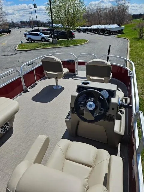 Slide: The Image of 2025 Sun Tracker Bass Buggy 16 XL Select pontoon boat with beige seating and steering console. - 4