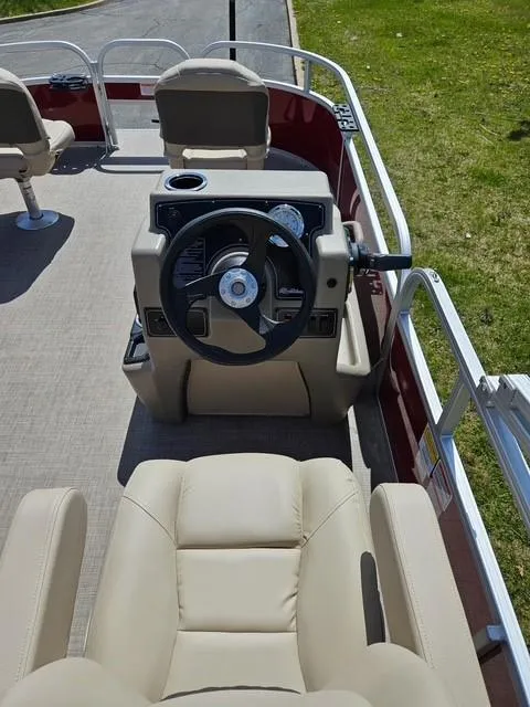 Slide: The Image of 2025 Sun Tracker Bass Buggy 16 XL Select boat interior with steering wheel and seating. - 5