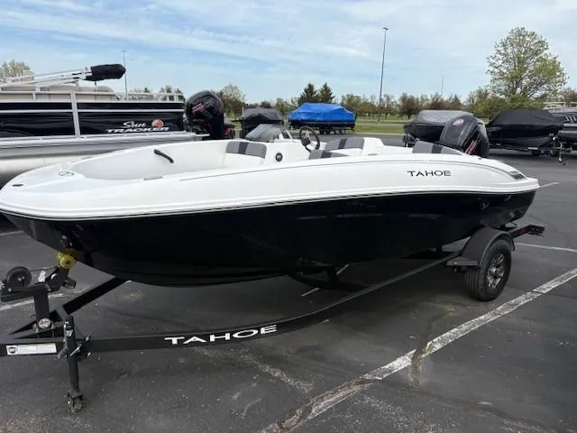 The Image of 2025 Tahoe T18 boat on trailer in parking lot, black and white design. - 0
