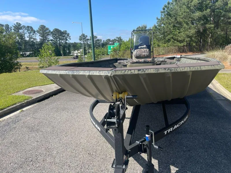 Slide: The Image of 2025 Tracker Grizzly 2072 CC boat on trailer in outdoor setting. - 2