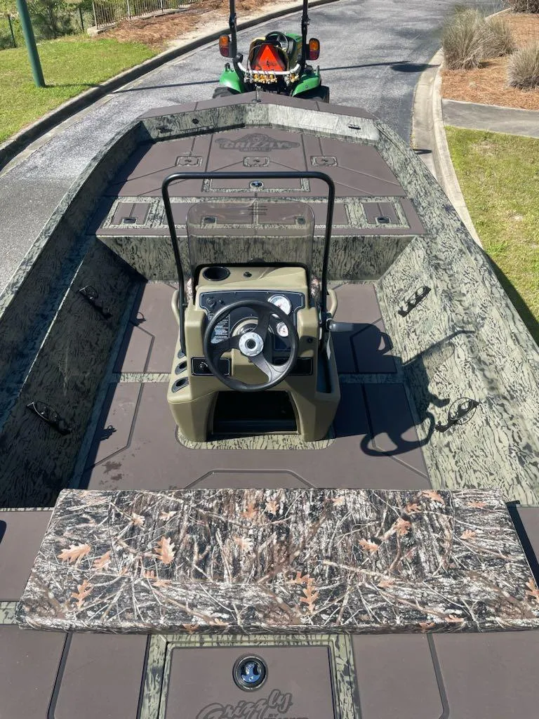 Slide: The Image of 2025 Tracker Grizzly 2072 CC boat with camo design and central steering console. - 8
