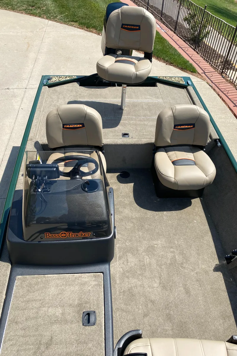Slide: The Image of 2025 Tracker Bass Tracker Classic Limited boat with beige seating and steering console. - 4