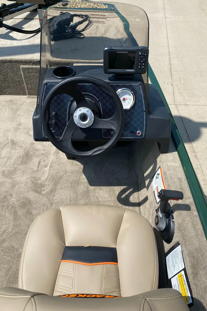 Slide: The Image of 2025 Tracker Bass Tracker Classic Limited boat dashboard with steering wheel and gauges. - 5