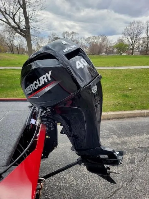 Slide: The Image of 2025 Tracker Panfish 17 with Mercury 40 outboard motor, parked on a paved surface. - 2
