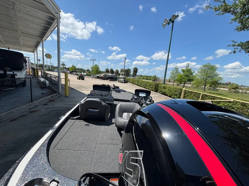 Slide: The Image of 2024 Nitro Z18 boat with sleek design, parked outdoors under a clear blue sky. - 1