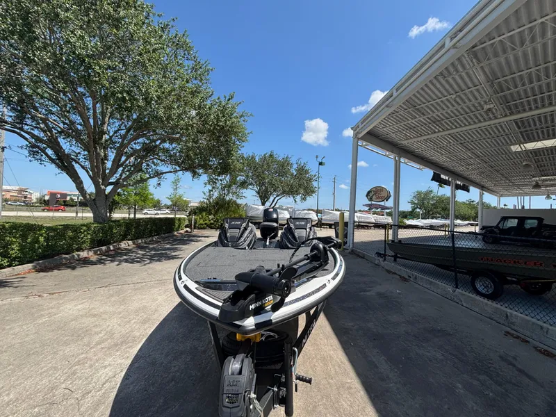 Slide: The Image of 2024 Nitro Z18 boat parked outdoors under clear blue sky. - 3