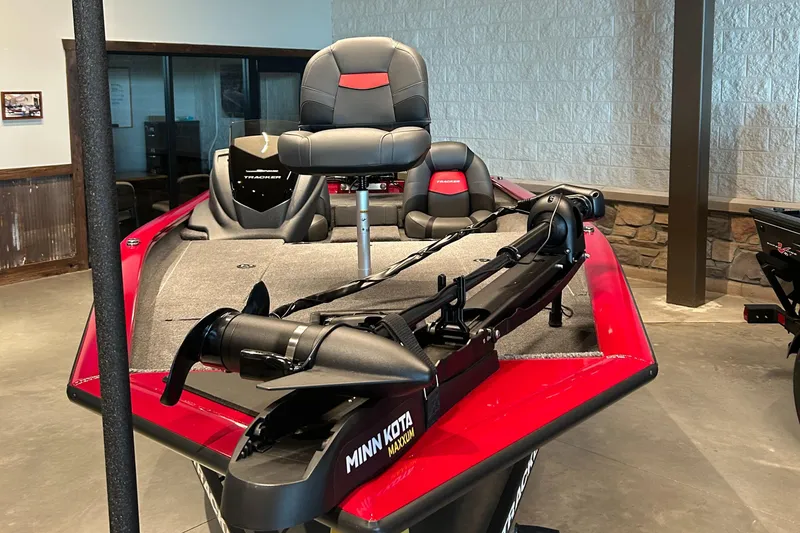 Slide: The Image of 2025 Tracker Pro Team 190 boat with Minn Kota motor, red and gray interior. - 2