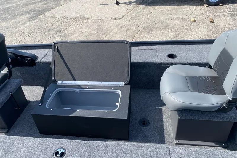 Slide: The Image of 2025 Tracker Panfish 17 boat interior with open storage compartment and seating. - 2