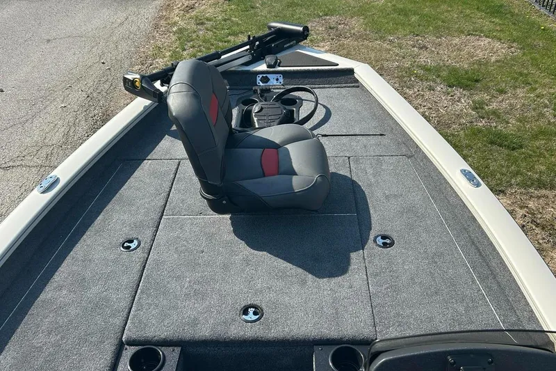 Slide: The Image of 2025 Tracker Pro Team 175 boat interior with gray seating and steering console. - 2