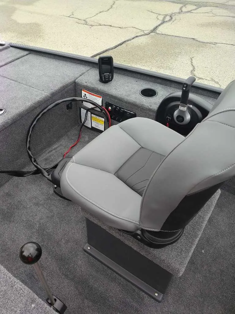 Slide: The Image of 2025 Tracker Panfish 17 boat interior with gray seating and control panel. - 2