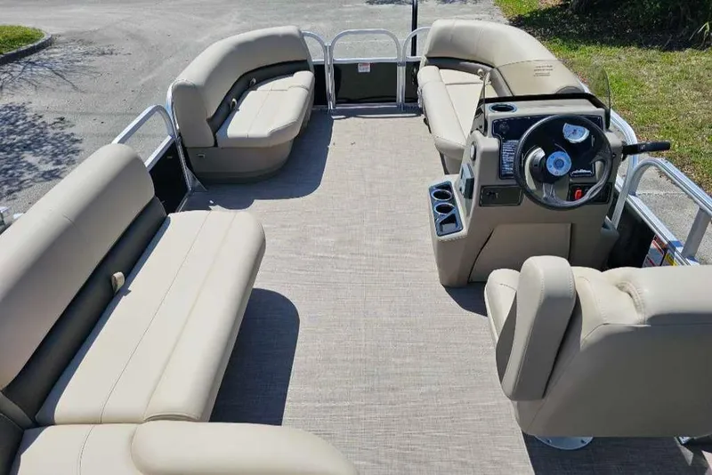 Slide: The Image of 2025 Sun Tracker Party Barge 16 DLX interior with spacious seating and modern helm. - 6