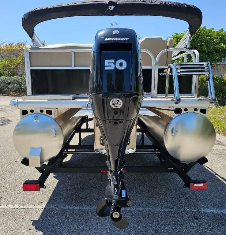 Slide: The Image of 2025 Sun Tracker Party Barge 16 DLX with Mercury 50 engine, rear view. - 9