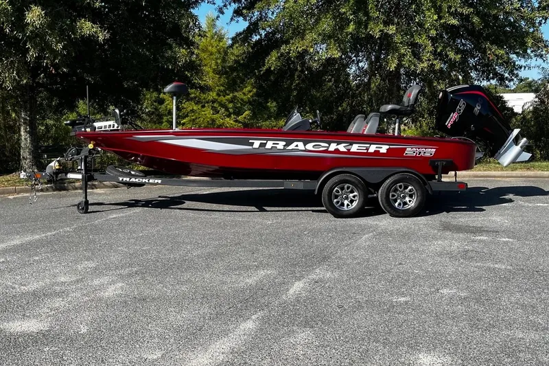 Slide: The Image of 2025 Tracker Savage 215 boat on trailer, parked outdoors, side view. - 4